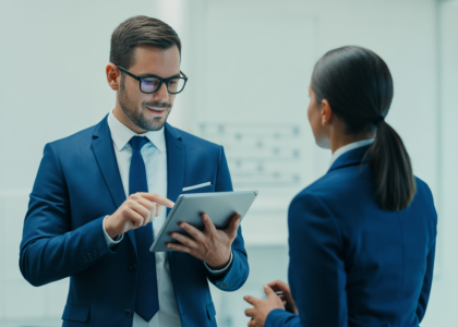 Cybersecurity consultant discussing digital protection with a Canadian business owner in a modern office